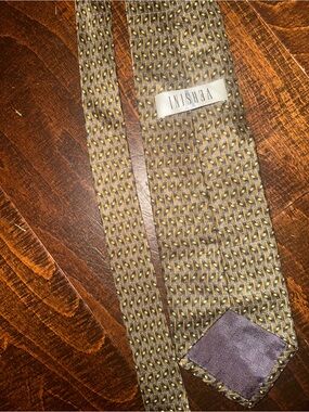 Versini brand necktie features a textured, olive green geometric pattern